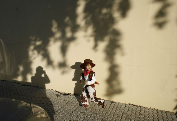 24 hours in pictures: Boy dressed as a cowboy at Epiphany parade in Seville