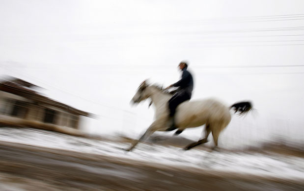 24 hours in pictures: Izvoru, Romania: A man competes in a traditional  horse race on Epiphany