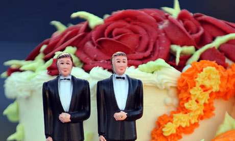 A wedding cake with statuettes of two men Portugal's parliament has passed