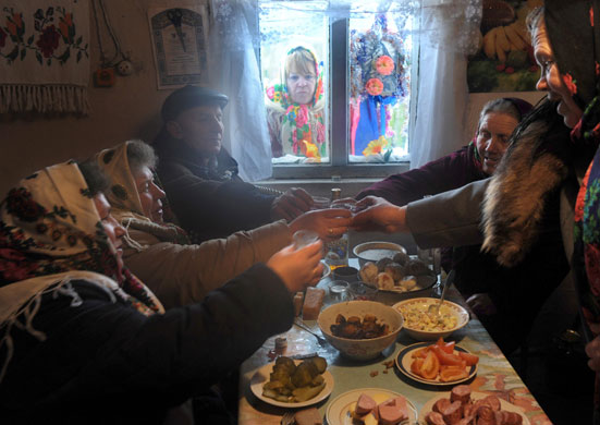24 hours in pictures: People celebrating Orthodox christmas perform a toast with vodka in Belarus