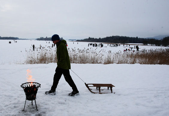 Snow: A sledger heads onto the frozen Lake of Menteith