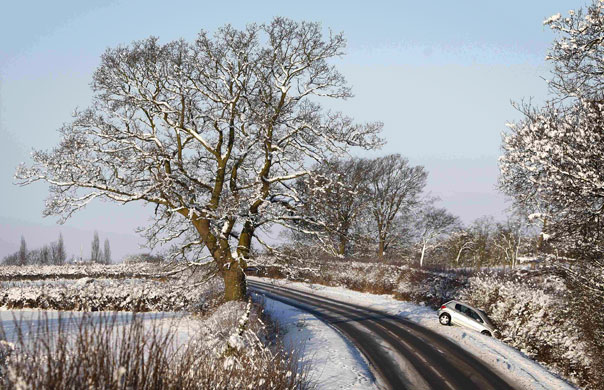 Snow: An abandoned car is seen in a ditch in Princes Risborough