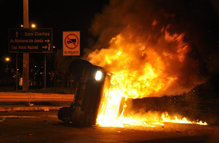 Ecuador Crisis Update: A vehicle belonging to the security detail of President Rafael Correa burns