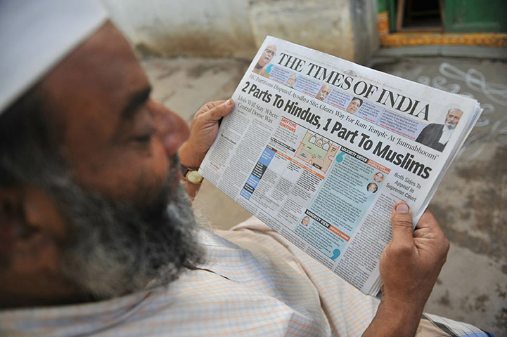 Ayodhya Update: An Indian Muslim man reads a newspaper with the high court verdict