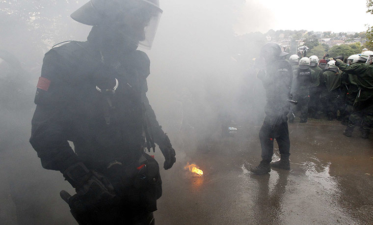 Stuttgart 21 Protest: Policemen walk through smoke from a flare during a protest in Stuttgart