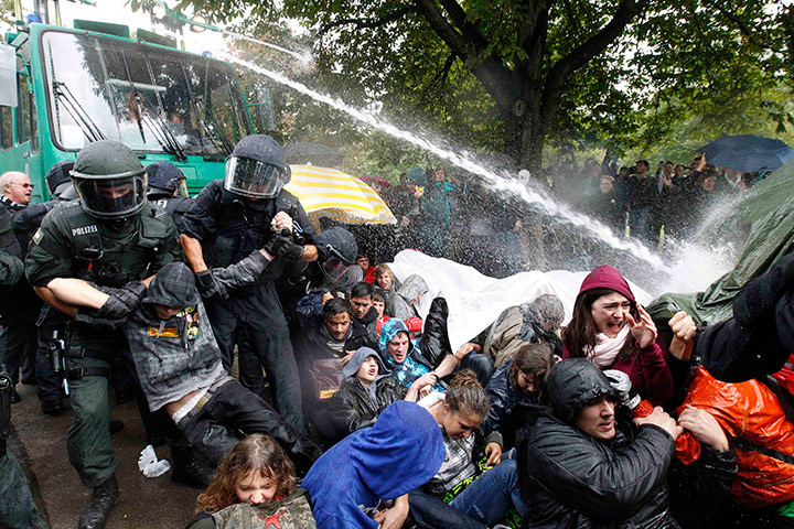 24 hours in pictures: Policemen use water canons to remove protestors from a park, Stuttgart