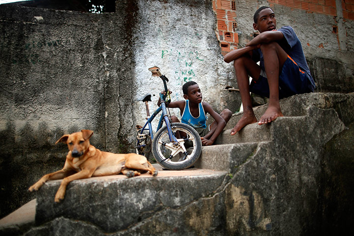 24 hours in pictures: Boys sit on stairs at Salgueiro slum, Brazil