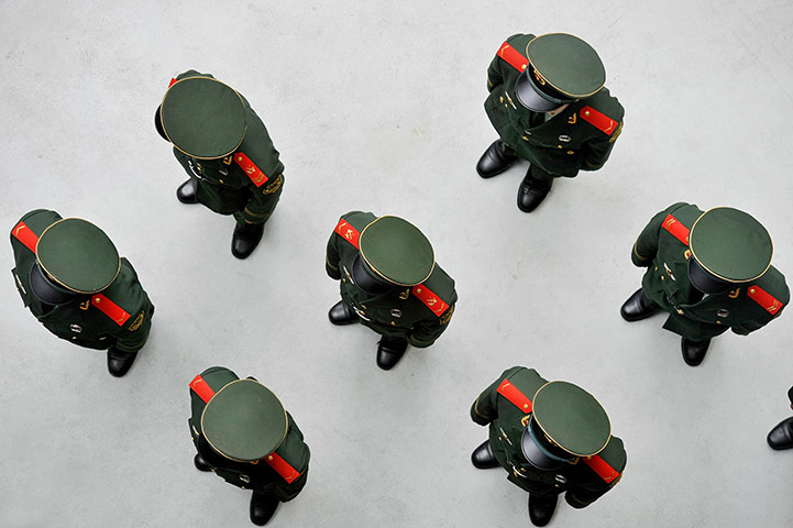 24 hours in pictures: hinese soldiers stand in line at the World Expo 2010