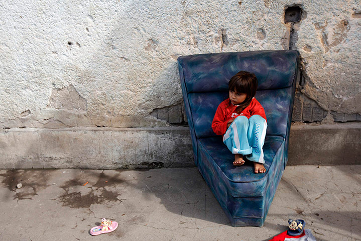 24 hours in pictures: A Roma girl sits outside her home in Alsozsolca, northeast of Budapest