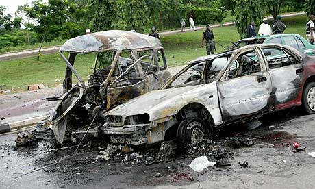 At least eight people were killed in two car bombs outside the  justice ministry in Abuja, Nigeria