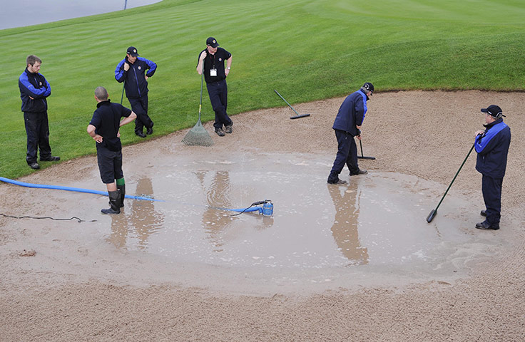 RYDER CUP DAY 1: Green staff pump water from a bunker