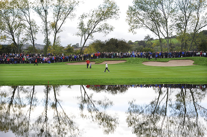 RYDER CUP DAY 1: Phil Mickelson makes his way down the 6th fairway before play restarts