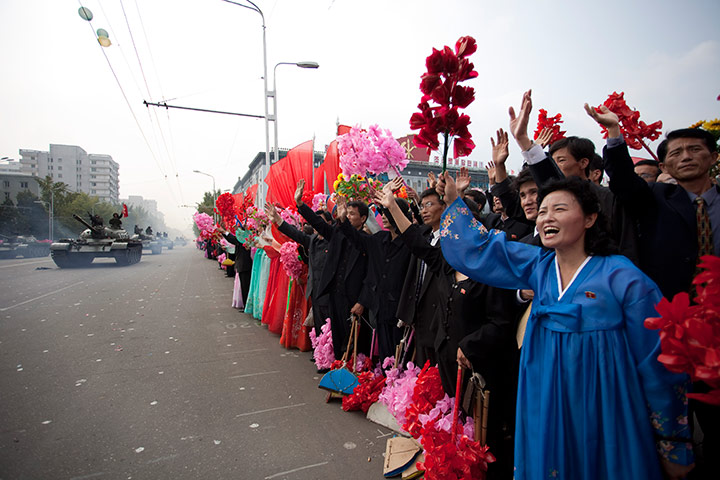 North Korea: North Korean tank crews wave to the crowds