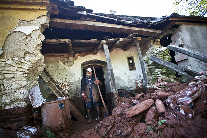 Hungary toxic sludge: An elderly local resident cleans his house and garden in Devecser