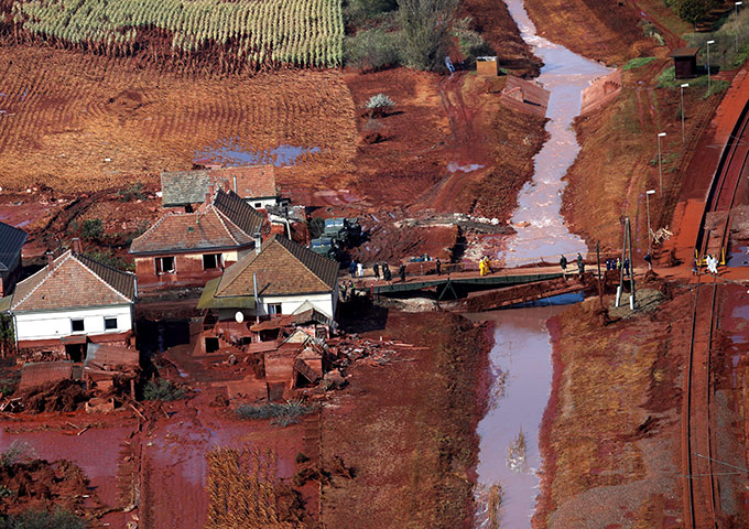 Hungary toxic sludge: Rescue team members crossing a bridge in Kolontar