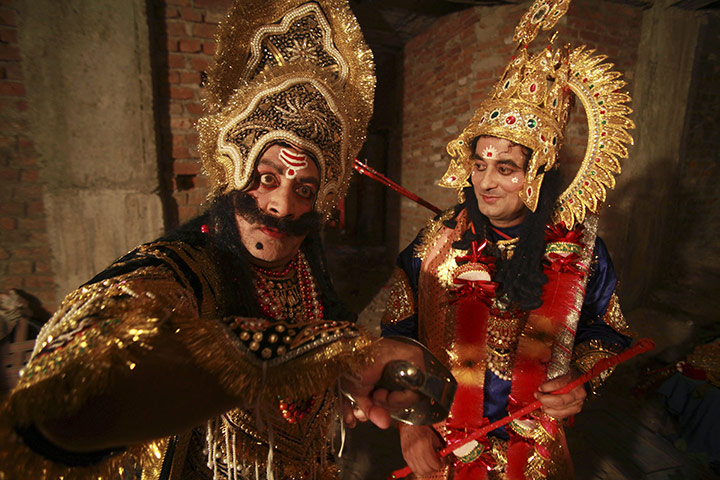 24 hours in pictures: Jammu, India: Actors dressed as the demon Ravan and the Hindu god Rama