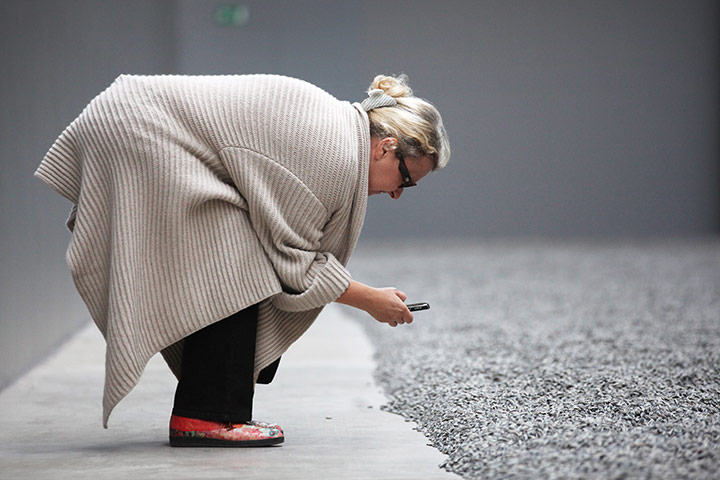  Turbine Hall: Lady takes close up of the Seeds