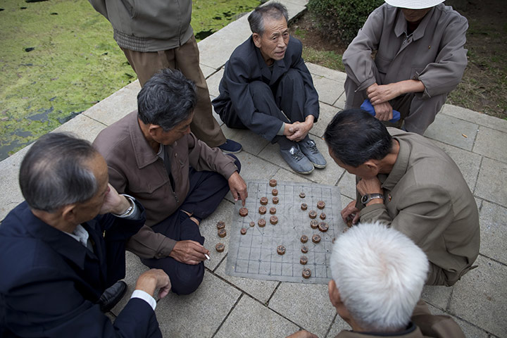 Dan Chung: Old men play Korean Chess near the Party Foundation Monunment in Pyongyang