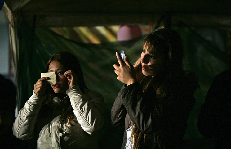 24 hours in pictures: relatives of trapped chilean miners prepare for a TV interview