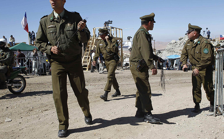 Trapped Chile miners: 12 October: Chilean policemen prepare a barrier