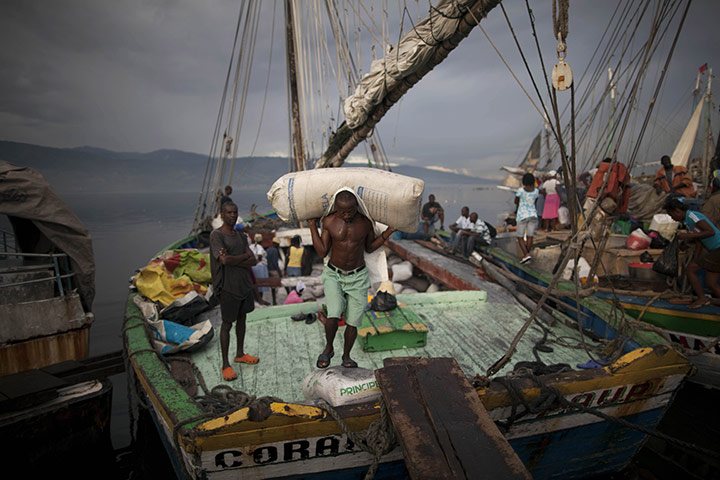 Ramon Espinosa: A man unloads sacks of coal at the port of Port-au-Prince, Haiti