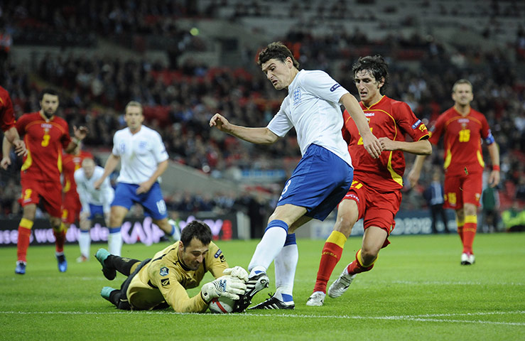 England v Montenegro 3: Mladen Bozovic bravely dives at the feet of Gareth Barry