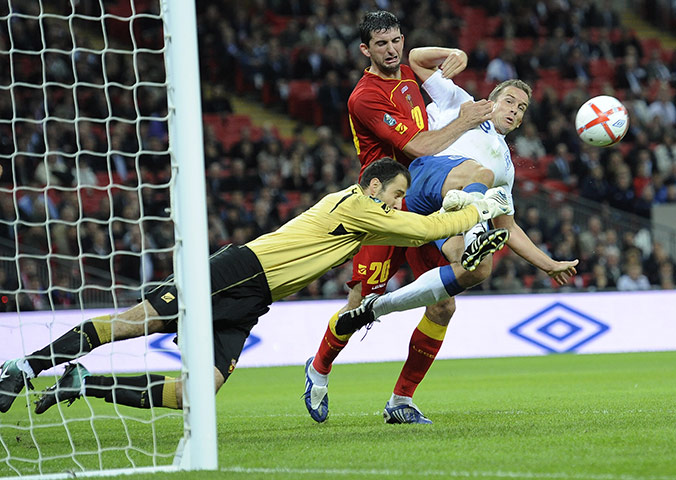 England v Montenegro 3: Mladen Bozovic dives to punch clear of Kevin Davies