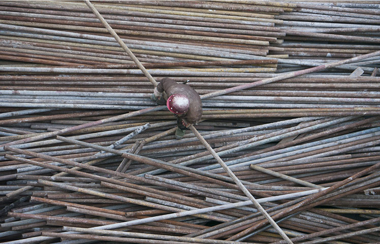 24 hours: Beijing, China: Construction workers build scaffolding