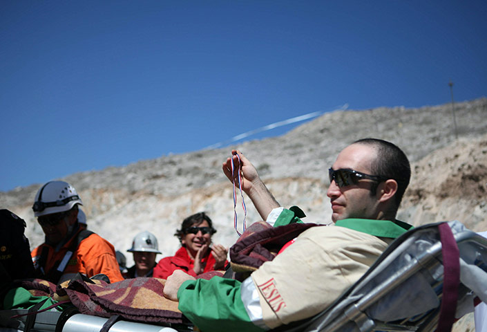 Chile miners rescue: Carlos Barrios, 24, is taken on a trolley to the field hospital