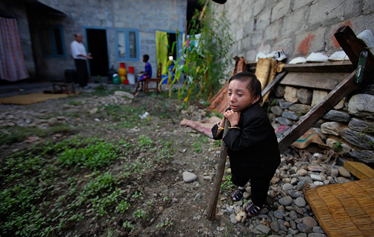 Khagendra Thapa Magar: Khagendra Thapa Magar stands in the compound of his home
