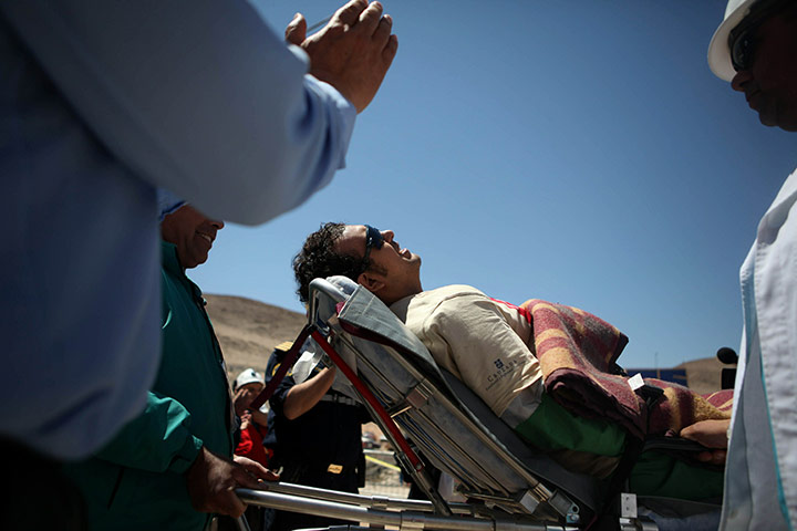 Chile miners are rescued: Daniel Herrera, 27, is taken on a trolley to the field hospital