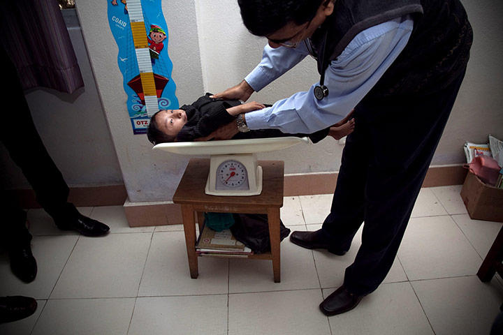 Khagendra Thapa Magar: Khagendra Thapa Magar is being weighed in front of Marco Frigatti