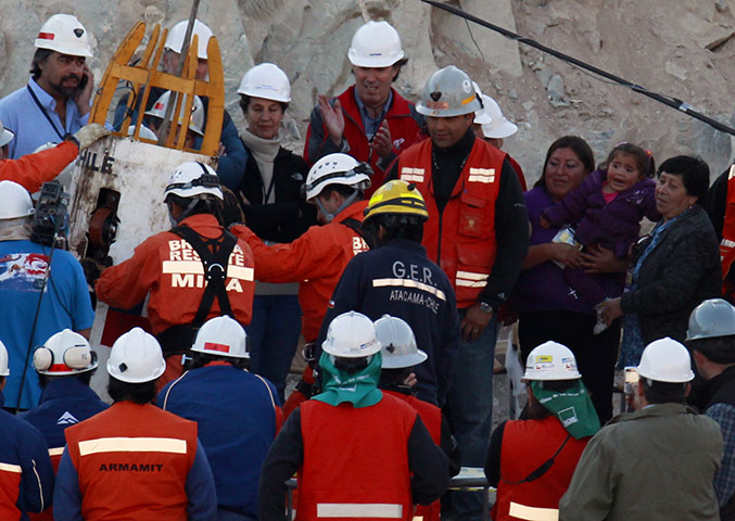 Rescued Chile miners: The family of miner Claudio Acuna Cortes, right, watch his rescue