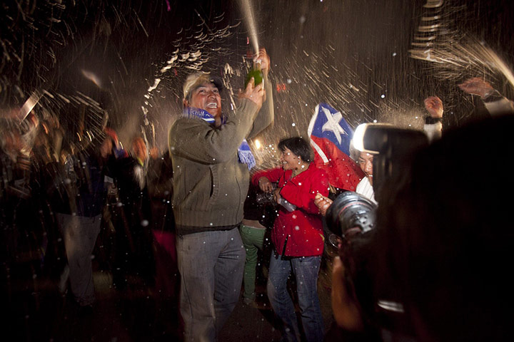 Rescued Chile miners: Relatives of the 33 Chilean miners celebrate the arrival of Luiz Urzua