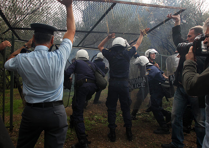 Protest at Acropolis: Riot police use a side entrance to enter the compound 