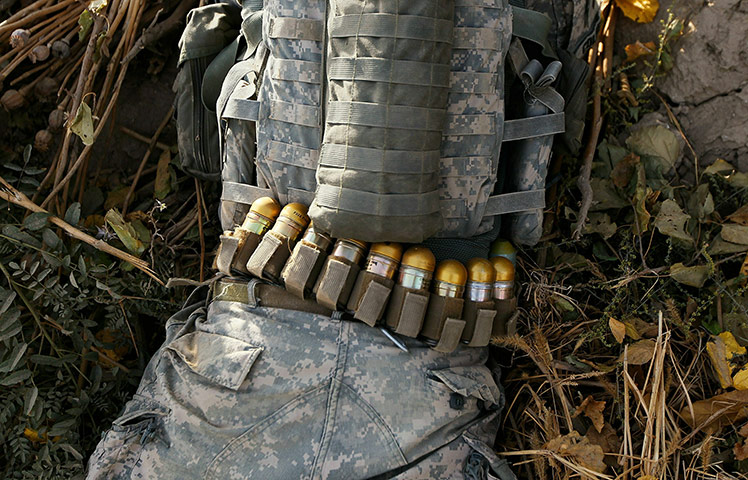 24 hours: US soldier n lies in the dirt with a belt full of grenades, Afghanistan
