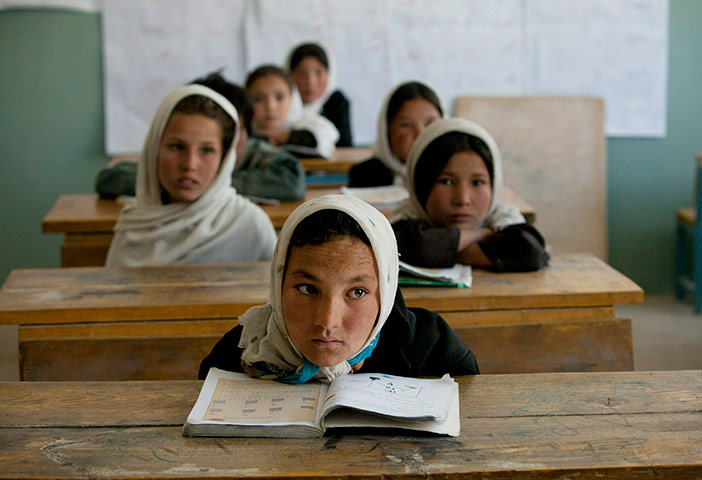 24 hours: Afghan girls listen during class at the Markaz high school
