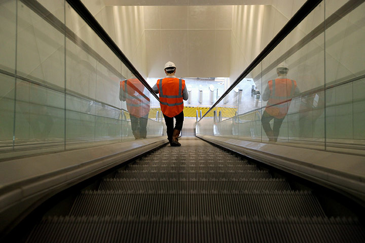 Week in Business: A workman uses the escalators in the One New Change shopping mall in London