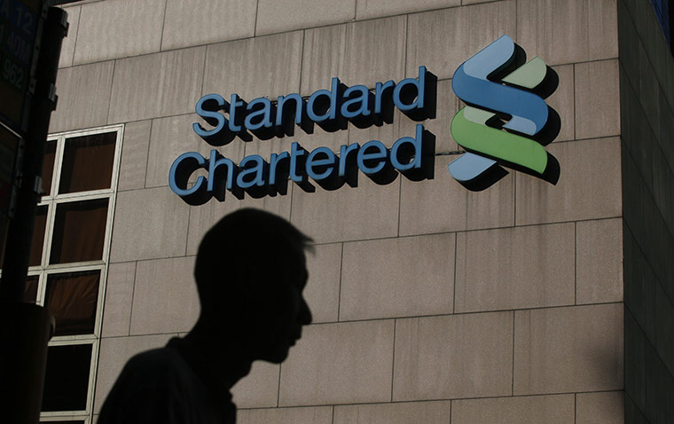 Week in Business: A  man walks pass the Standard Chartered Bank headquarters in Hong Kong