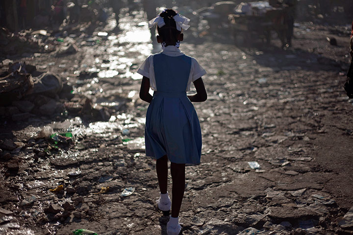 Ramon Espinosa: A girl walks on her way to school in downtown In Port-au-Prince, Haiti