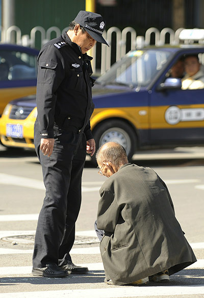Communist Party Chinaq: A policemen tells an old man to move on