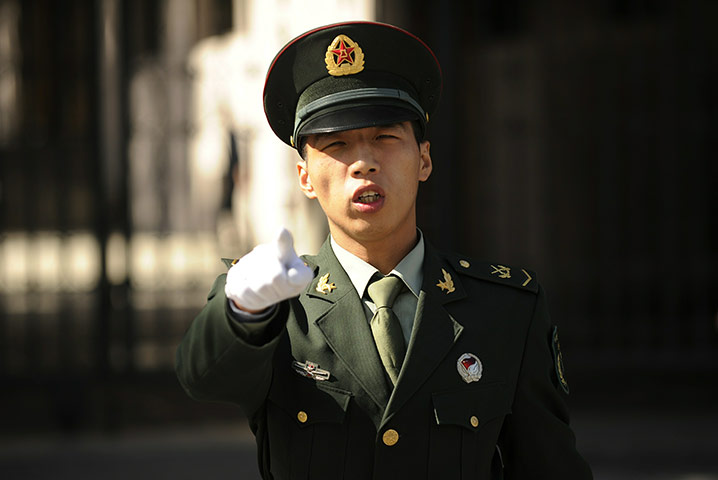 Communist Party Chinaq: A PLA soldier stops photographs being taken in Beijing