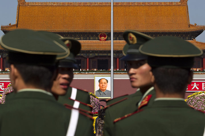 Communist Party Chinaq: Paramilitary policemen look back while patrolling on the Tiananmen Sqaure