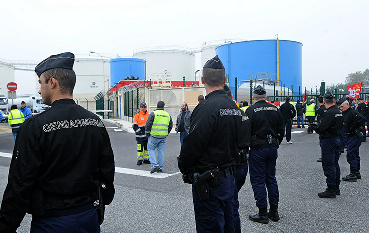 France Strikes: Gendarmes stand in front of striking employees of a fuel dept near Toulouse
