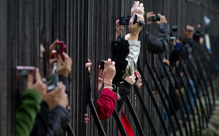 24hours: Members of the public take photos and videos through the fence