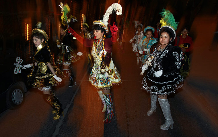 chile miners go home: Women dance during a costumes parade for the rescued miners in Copiapo
