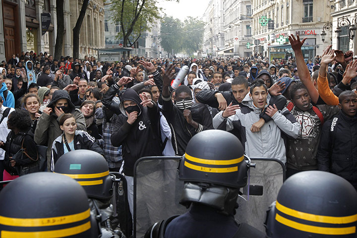 France Strike Update: High school students face police officers during a demonstration in Lyon