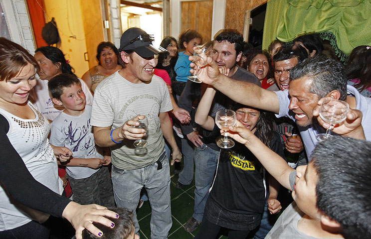 Chile miners return home: Ticona toasts with family and friends upon arriving home in Copiapo