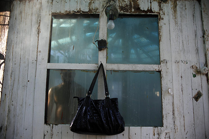 24 hours in pictures: Managua, Nicaragua: A man in a sauna is seen through a window 