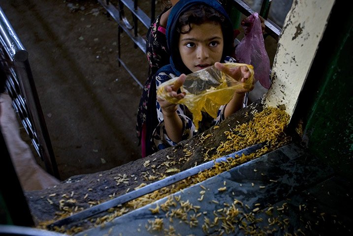24 hours in pictures: Islamabad, Pakistan: A Pakistani girl receives free food 